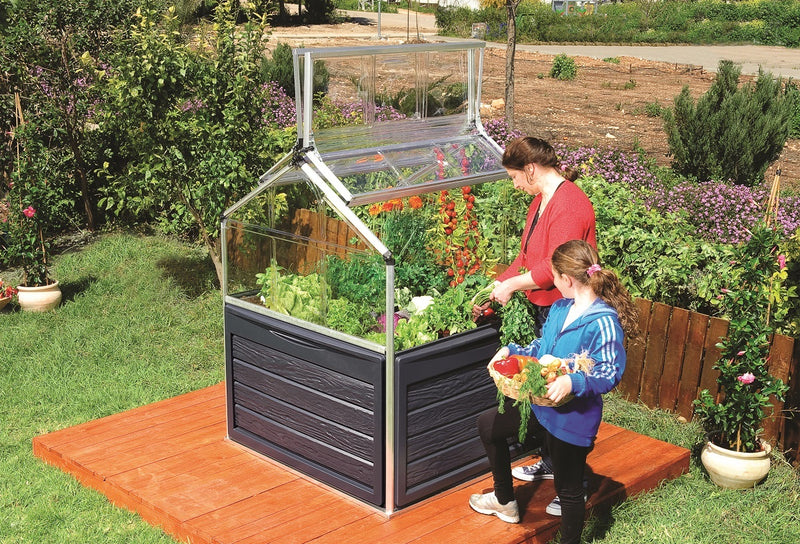 Mother and child working on the Plant Inn elevated garden bed